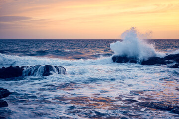 Splashes from the waves bumping against the rocky shore