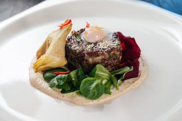Filet mignon served on a white plate in restaurant