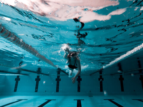 Woman crawling in a pool preparing for a competition