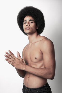 Young Confident Black Man With Six Pack Abs And Afro Hairstyle Looking At Camera On White Background