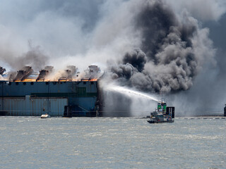 St Simons Island, GA USA - May 14 2021: Fire breaks out during demolition of Golden Ray cargo ship...