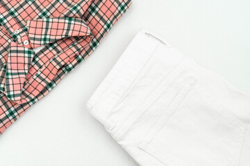 summer flat lay: shirt with a pink check pattern and white jeans 