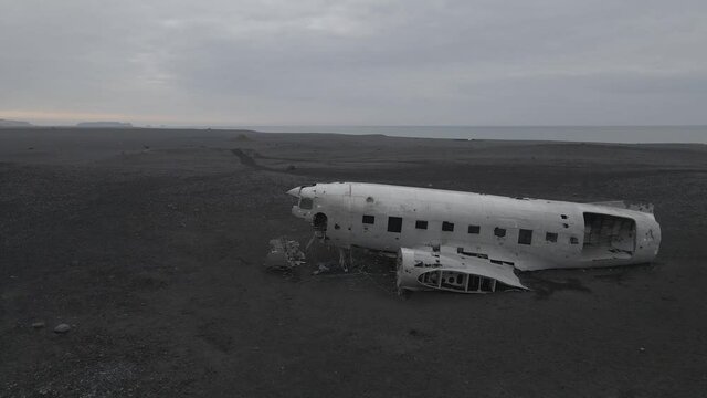 Aerial forward over airplane relict Douglas Dakota DC3 or C-117 on south coast of Iceland