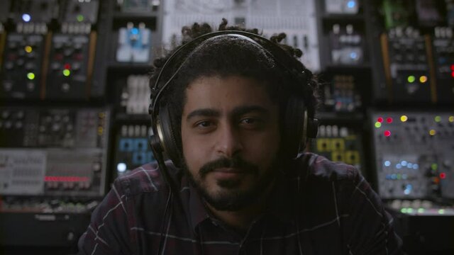 Cool music producer thinking about his next big single.  