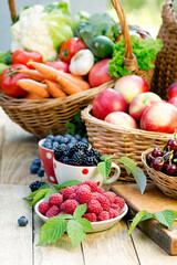 Basket of fresh fruits and vegetables, healthy organic vegetarian food on table