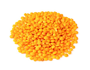 handful of hulled red lentils closeup on white
