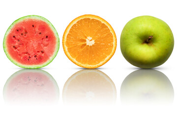 Half watermelon, half orange and green apple on white background with reflection