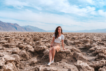 Fototapeta na wymiar Beautiful woman with long hair walks on the Devil's Golf course in Death Valley