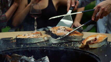 Unrecognizable man cooking food for grill party. Man chef using kitchen tools