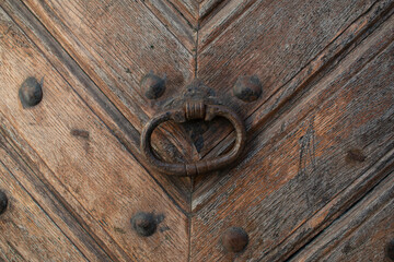 Old wooden door with a metal wrought iron lock. Castle, fortress 