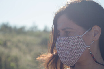 Closeup shot of a female in a facial mask - a new normal concept