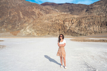 Girl in a skirt visits the dried up salt lake Bad Water Basin in Death Valley