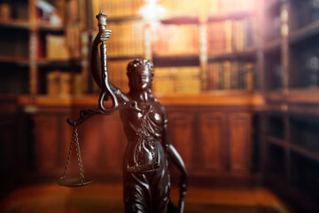 Justice and law concept.Male judge in a courtroom with the gavel, working with, computer and docking keyboard, eyeglasses, on table in morning light