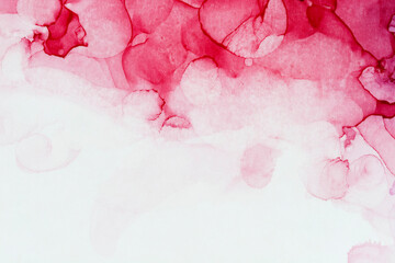 Macro close-up of red alcohol ink layers and splashes, abstract background. Fluid ink, full frame...