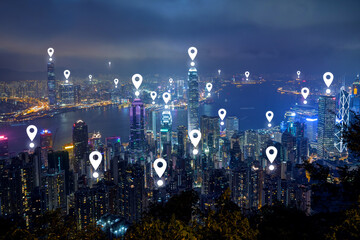 Map pin icons on Hong Kong's skyline at dusk. Hong Kong's famous skyline viewed from above from the Victoria Peak at night. - obrazy, fototapety, plakaty