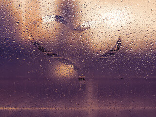 Dirty surface of cracked misted glass with small dew drops