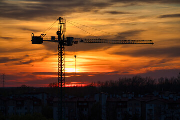 Fototapeta premium Construction crane silhouette at sunset