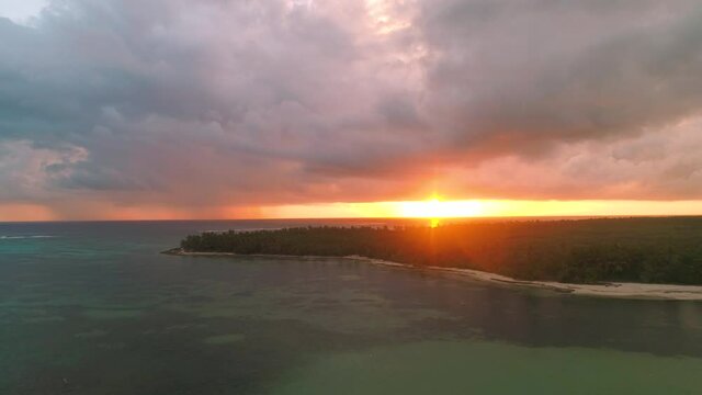 Burning sky sunset after tropical storm and exotic caribbean island Saona, Dominican Republic. Aerial drone view