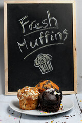 Variety of fresh muffins with a sign blackboard