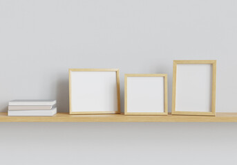 Three photo mockup frames and books on the shelf. Clipping path included. 3D render. 3D...