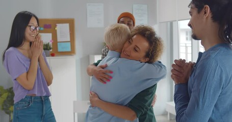Two women hugging at mental health group therapy meeting - Powered by Adobe