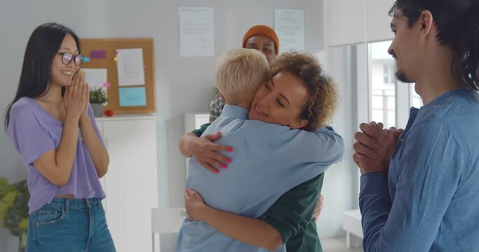 Two women hugging at mental health group therapy meeting