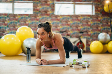 Woman in a plank pose in a gym