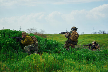 The soldiers hiding behind the hill are fighting