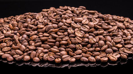 Coffee beans. Dark Roast Coffee whole bean. Food photography. Macro High resolution photo Full depth of field Isolated on black background. Good for cafe, restaurant, shop, banner, posters, billboards