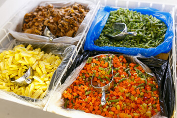 Frozen vegetables in the refrigerator of the store.
