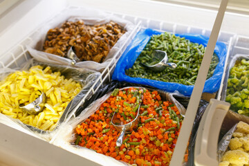 Frozen vegetables in the refrigerator of the store.