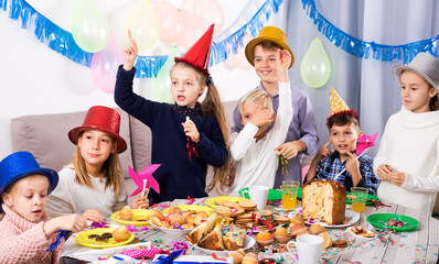 children giving presents to little girl during party