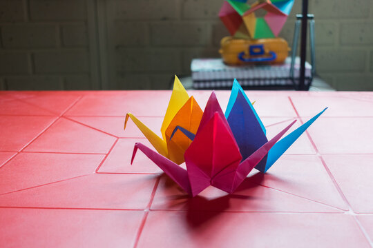 colorful cranes on a red plastic table
