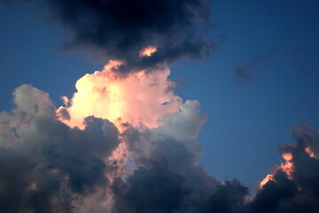 Fototapeta premium Dramatic Contrast Skyscape Evening Dusk Sunset With Orange Clouds. Dramatic Orange Sunset. Colorful Clouds Background. Low Angel View Of Dramatic Clouds Formations.