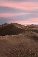 Fototapeta na wymiar A view of desert dunes at sunset
