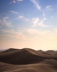 Fototapeta na wymiar A view of desert dunes at sunset