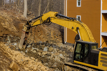 Tractor for crushing large stones in a during earthmoving works at construction site at mountain