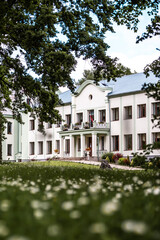 Fototapeta na wymiar Malnava Manor - a place in Latvia where Adolf Hitler visited during the war. A typical huge film manor and its garden