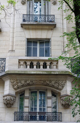 Traditional French house with typical balconies and windows. Paris.