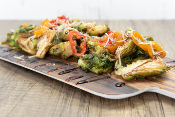 Roasted brussel sprouts presented perfectly drizzled with special sauce