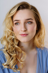 Fototapeta premium Woman with long curly hair and absolutely clear skin