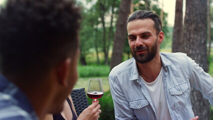 Joyful friends relaxing outside. Romantic couple showing tenderness party