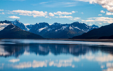 Naklejka na ściany i meble calm waters of Cook inlet near Anchorage, Alaska w/ snow capped mountains on the background.