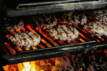 burger cutlets on a grill - cutlets made from organic beef. raw cutlets