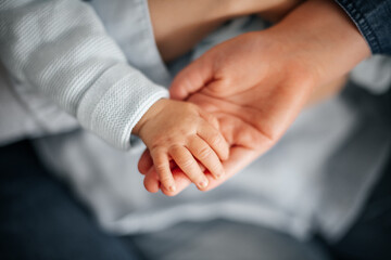 Obraz premium an der Hand der Mutter die Hand eines kleinen Kindes