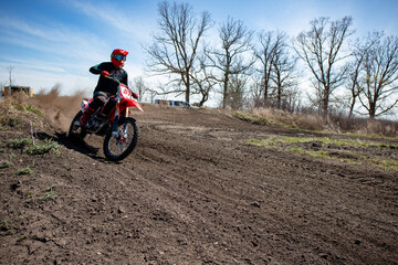 Fototapeta na wymiar Motocross rider exits a corner with great speed.