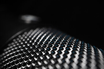 Abstract Macro Closeup of Large Diaphragm Condenser Microphone Grill Isolated in Darkness