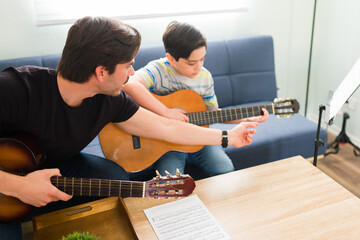 Instructor giving private guitar classes to children