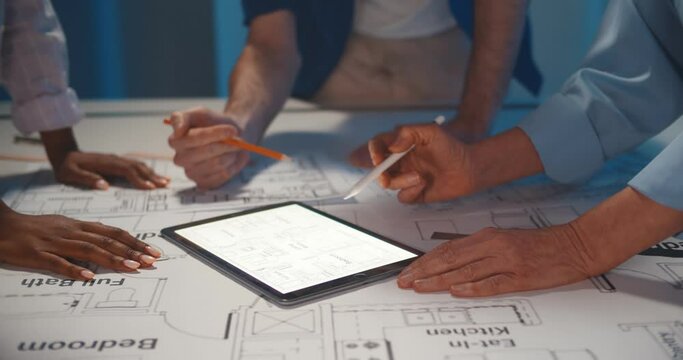 Close-up of team architects working on construction project in office