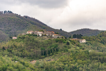 Fototapeta na wymiar Small medieval town. On a high hill in the Tuscan mountains is an old Italian town. Spring in May in Italy